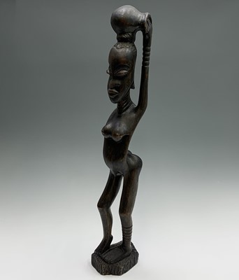 Lot 113 - An African carved hardwood tall tribal figure...
