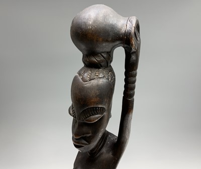 Lot 113 - An African carved hardwood tall tribal figure...