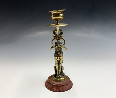 Lot 123 - A late Victorian brass candlestick, cast as a...
