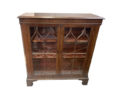 Lot 3045 - A George III mahogany bookcase, with a pair of...