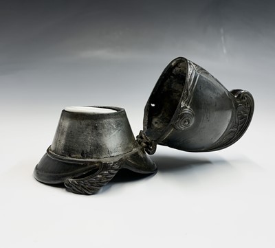 Lot 90 - A pewter inkwell modelled as a fireman's...