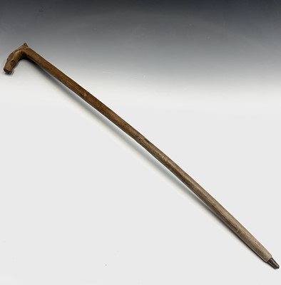 Lot 129 - A carved wood walking stick, the handle carved...