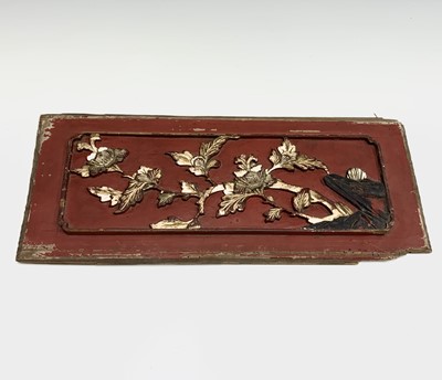 Lot 186 - Two Chinese red painted carved wood panels,...