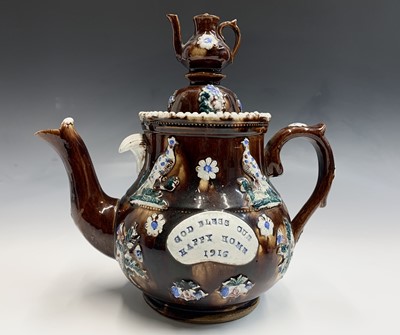 Lot 829 - A Measham treacle glazed bargeware teapot,...