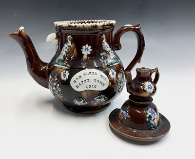 Lot 829 - A Measham treacle glazed bargeware teapot,...