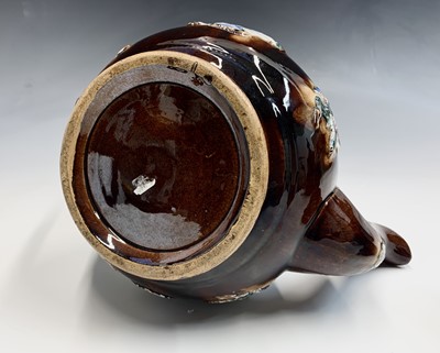 Lot 829 - A Measham treacle glazed bargeware teapot,...