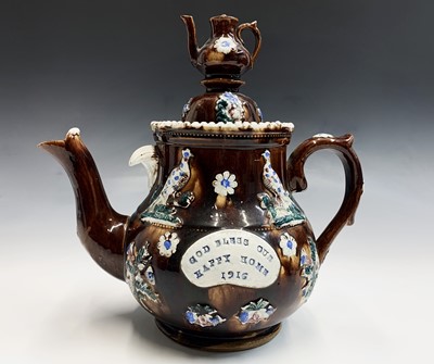 Lot 829 - A Measham treacle glazed bargeware teapot,...