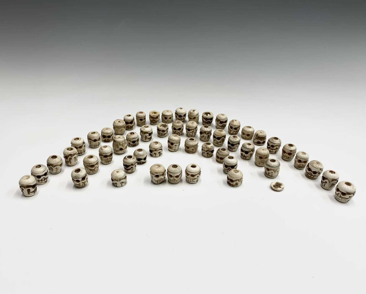 Lot 72 - Fifty-three Tibetan bone skull beads,.largest...