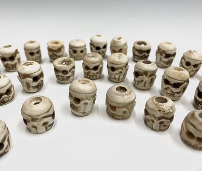 Lot 72 - Fifty-three Tibetan bone skull beads,.largest...