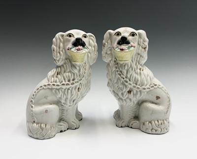 Lot 863 - A pair of Staffordshire seated spaniels, with...