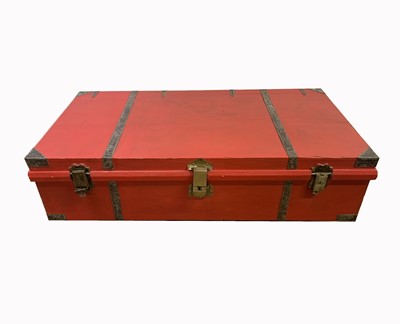 Lot 3082 - A red painted wooden trunk, the brass lock...