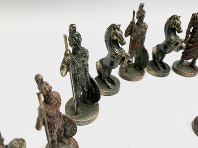 Lot 57 - A cast metal Hellenistic style chess set,...