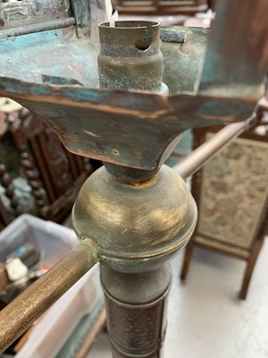 Lot 83 - A tall copper and brass lamp, modelled as a...