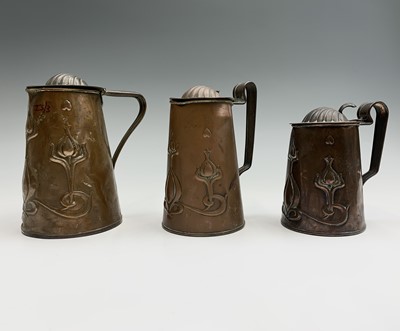 Lot 166 - Three Art Nouveau copper jugs, in sizes, the...