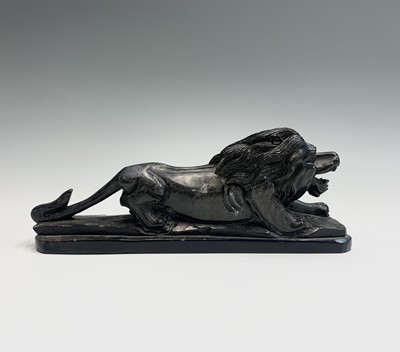 Lot 191 - A carved stone model of a crouching lion,...