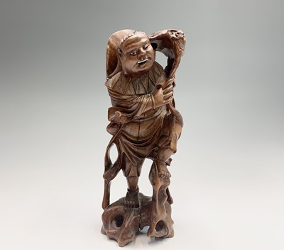 Lot 143 - A Chinese carved rootwood figure of buddha...