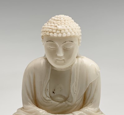 Lot 147 - A Chinese carved ivory figure of a seated...