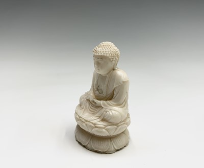 Lot 147 - A Chinese carved ivory figure of a seated...