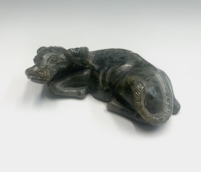 Lot 156 - A Chinese soapstone carving of a recumbent...