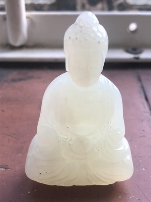 Lot 63 - A small Chinese jade figure of a seated Buddha,...