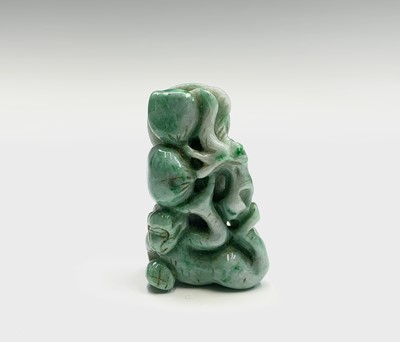 Lot 181 - A Chinese jade figure of a monkey beneath a...