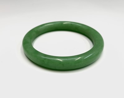 Lot 166 - Three Chinese jade bangles, diameter 8cm, 7cm...