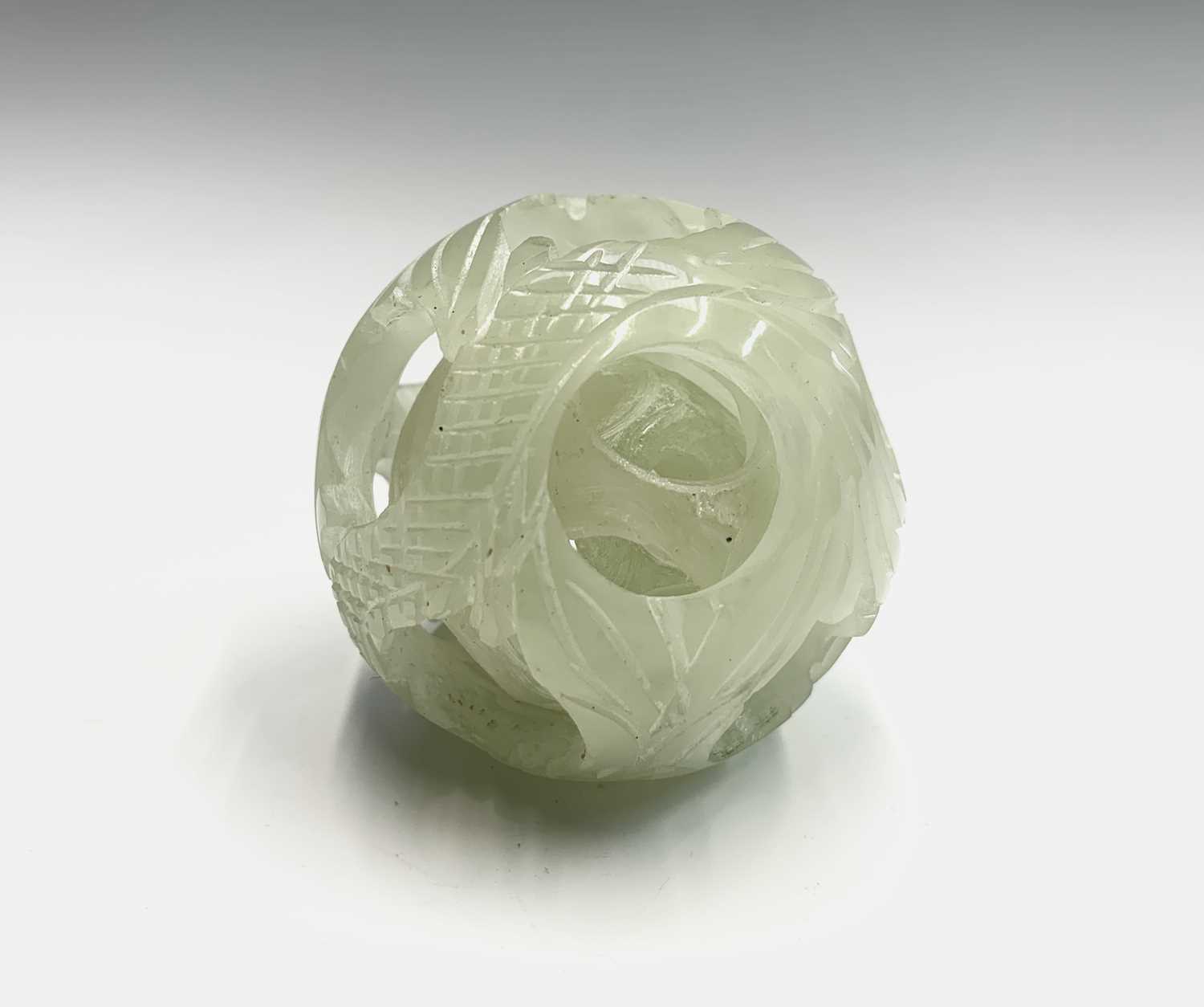 Lot 192 - A carved greenstone puzzle ball, diameter 5.5cm.