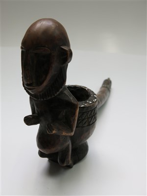 Lot 87 - An African wooden pipe, with carved figural...