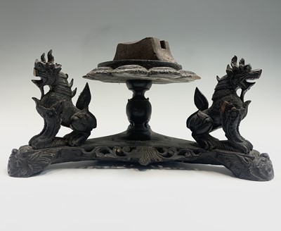 Lot 22 - A Burmese carved hardwood stand, mounted with...