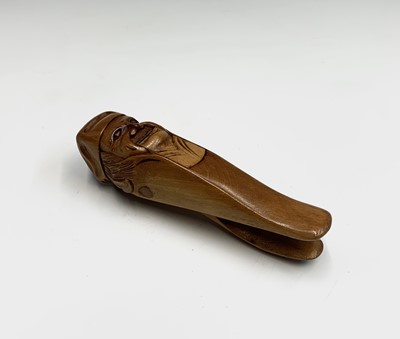 Lot 24 - A treen nutcracker, early 20th century, carved...