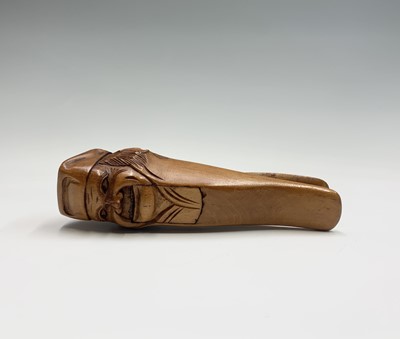 Lot 24 - A treen nutcracker, early 20th century, carved...