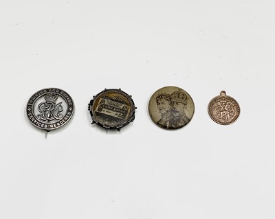 Lot 25 - A World War I silver discharge badge, four...