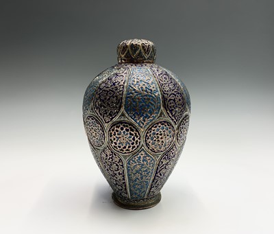Lot 1040 - A Persian enamelled copper vase and cover,...