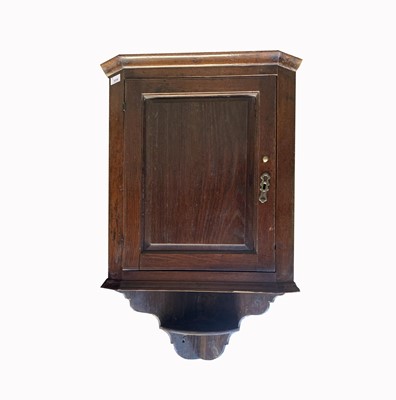 Lot 3098 - A George III oak hanging corner cupboard, the...