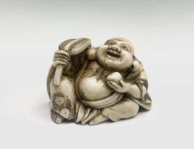 Lot 203 - A Japanese ivory netsuke of a seated Hotei...