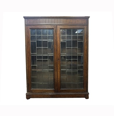 Lot 3111 - An oak bookcase, circa 1920's, with a pair of...