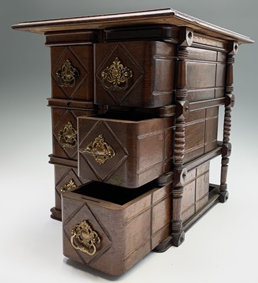 Lot 73 - A Continental walnut miniature chest of...