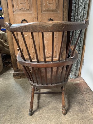 Lot 75 - An ash and elm 'comb back' Windsor armchair,...