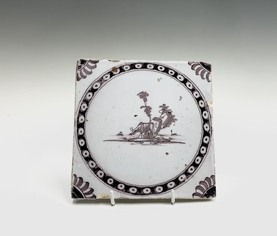 Lot 1036 - An 18th century delft tile, painted in...