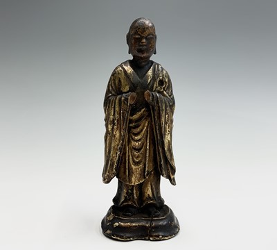 Lot 213 - A Chinese carved giltwood figure of man...