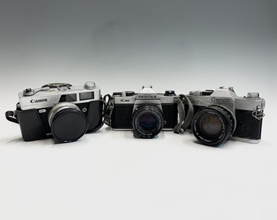 Lot 285 - Two Canon cameras, a QL SLR, cased and an FTb...