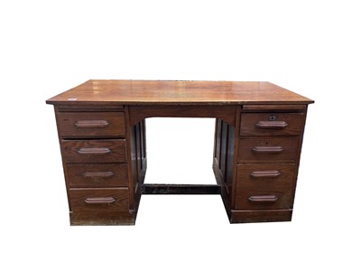 Lot 3189 - A 1920s oak twin pedestal desk, with eight...