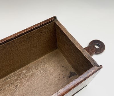 Lot 58 - A George III oak candle box, with sliding...