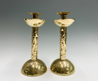 Lot 311 - A pair of Newlyn brass candlesticks, each...