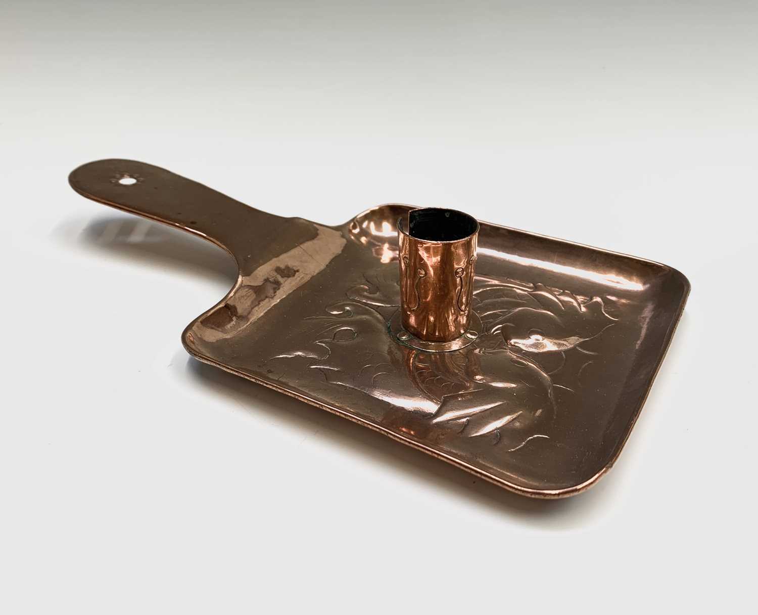 Lot 316 - A Newlyn copper chamber candlestick, repousse...