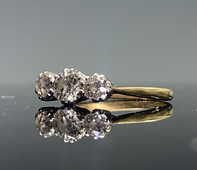 Lot 82 - An 18ct gold ring set with three bright...