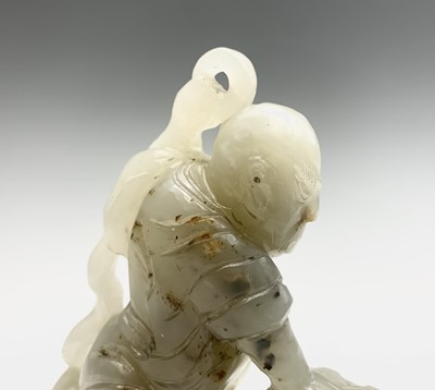 Lot 47 - A Chinese jade carving of a diminutive figure,...