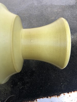 Lot 45 - A Chinese yellow glazed porcelain candlestick...