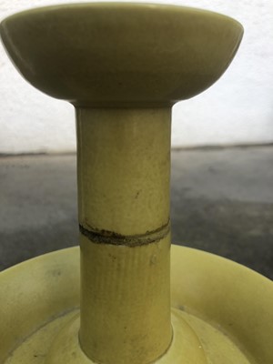 Lot 45 - A Chinese yellow glazed porcelain candlestick...