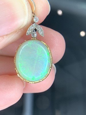 Lot 226 - An Edwardian gold-mounted opal pendant, it...